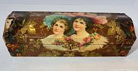 Top view of glove box showing Gibson Girl portraits, floral celluloid design, brass clasp