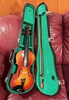 Violin in open case showing interior and bow placement