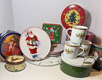 Group shot of mugs, plates, tray and assorted tins