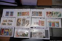 Overview of 11 stock cards filled with assorted stamps