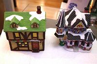 Both ceramic village cottages side by side