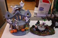 Both Halloween village pieces side by side on tabletop