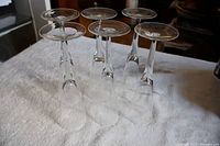 six crystal flutes inverted to show rims and bases
