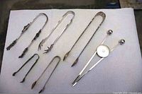 All six pairs of tongs laid out for overall view