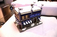 Front angled view of Toronto Maple Leafs Bowling Lanes building showing rooftop flags and awnings