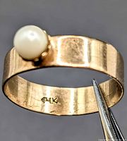 Interior 14k stamp on gold band with pearl visible