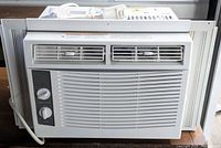 Front view showing grille, control knobs, side panels and power cord