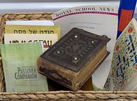 Group shot of photo album and assorted booklets in basket