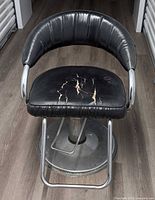 Front view of barber chair showing overall design and condition