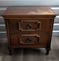 Front view showing drawers, hardware, legs, overall structure