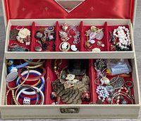 Overview of open jewelry box showing all costume jewelry pieces