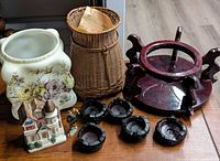 Group shot of planter, basket, wooden stand, four ashtrays, house figurine, metal figurine