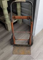 Full view of hand truck dolly standing upright