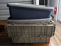 Three stacked totes: grey crate with folding lid, grey open tote, blue open tote nested