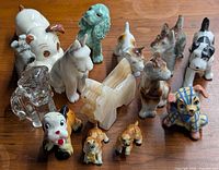All fourteen miniature dog figurines grouped on tabletop
