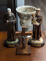 Overall view of both figurines, marble chalice and crucifix