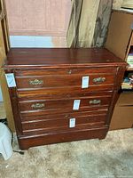 Front view showing three drawers and hardware