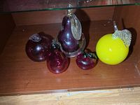 All five blown glass fruit figures on shelf