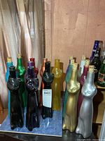 Group shot of coloured cat-shaped bottles on table