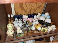 Full view of middle shelf showing entire assortment of salt and pepper shakers