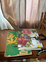 Binder and scrapbook on shelf