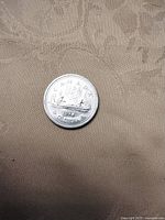 Reverse side showing voyageur canoe design and 1977 date