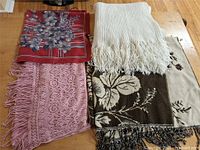 Four scarves laid out showing overall styles and colors
