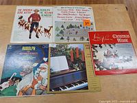 All five Christmas LPs laid out, front cover view