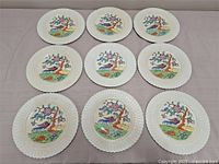 Full set of nine luncheon plates displayed face up