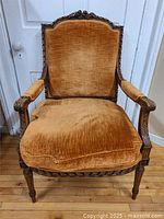 Full front view of carved oak bergere chair