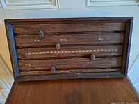 Front view of wooden score counter showing four rails and sliders