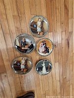 All five plates layout on floor showing designs and border pattern