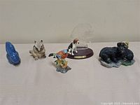 All five animal figurines lined up on table