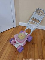 Full view of Fisher-Price plastic toy lawn mower
