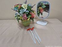 Full lot showing floral arrangement, mirror, and stir sticks