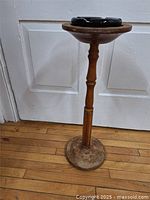 Full view of wooden pedestal ashtray stand