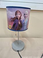 Full view of lamp showing shade with Frozen characters and metal base