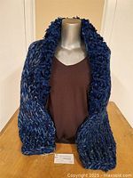 Front view on mannequin showing overall shape of shrug sweater