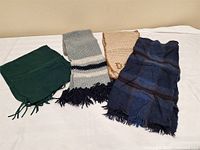 All four scarves laid out showing variety and condition