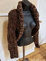 Full view of shrug on dress form, showing open front and sleeve length