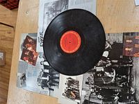 Top view of vinyl record on photo/lyric insert