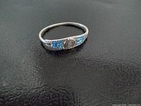 Full view of silver hinged bracelet on flat surface