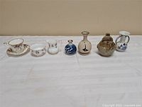 Group shot of all eight pieces lined on table