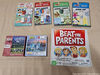 All items laid out: board game, two puzzles, four wipe-off activity pads