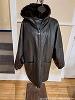 Faux leather side of coat front with hood and pockets