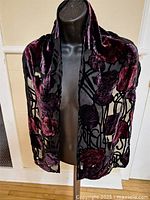 Full view of scarf draped on mannequin, showing size and pattern