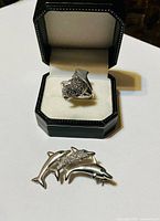 Ring in display box and brooch side by side