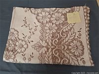 Folded floral lace tablecloth overall view