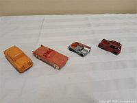 All four vehicles lined up on cloth background