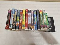 Row of 16 VHS tapes, assorted Disney and family titles